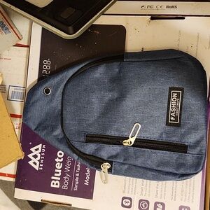 Denim sling bag, new in package. 2 compartments